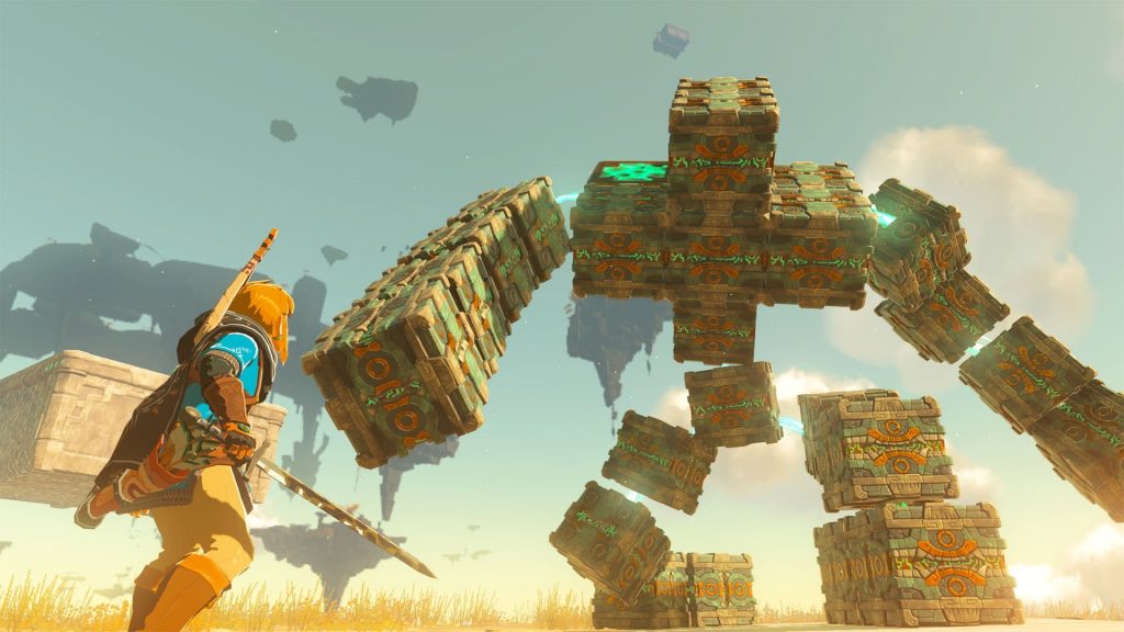 Imagem mostra Link de The Legend of Zelda: Tears of the Kingdom enfrentando um monstro de pedra.