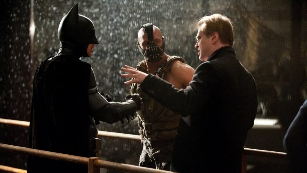 Batman (Christian Bale), Bane (Tom Hardy) e o diretor Christopher Nolan